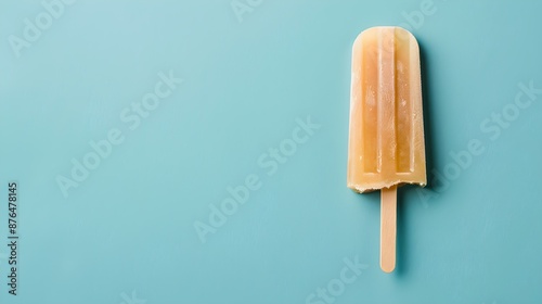 Light Brown Popsicle on a summery blue Background with Copy Space