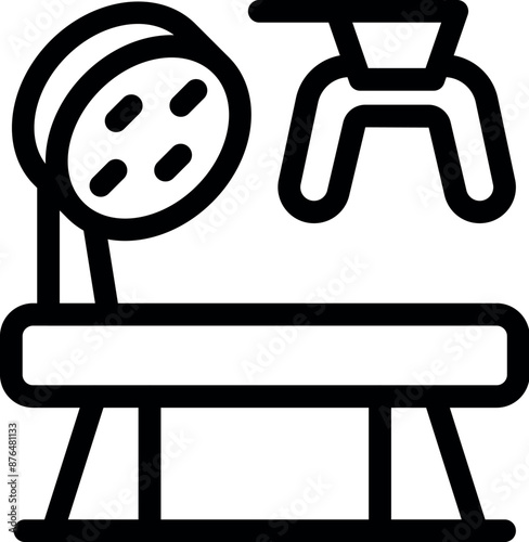 Black and white icon of a medical examination table with a lamp and stirrups