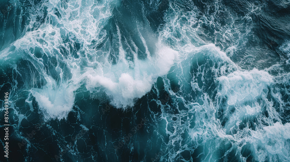 Waves crashing ashore, creating a foamy surface. The rough ocean water splashes against the coast. Waves crashing ashore, creating a foamy surface. The rough ocean water splashes against the coast.