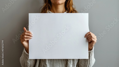 Woman Holding Blank A2 Poster Mockup on Isolated Gray Background photo