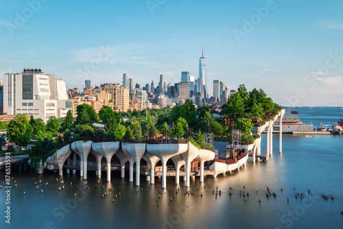 Fototapeta Naklejka Na Ścianę i Meble -  Long exposure of Little Island over the Hudson River in Chelsea, New York, with the lower Manhattan skyline as a stunning backdrop at dusk.