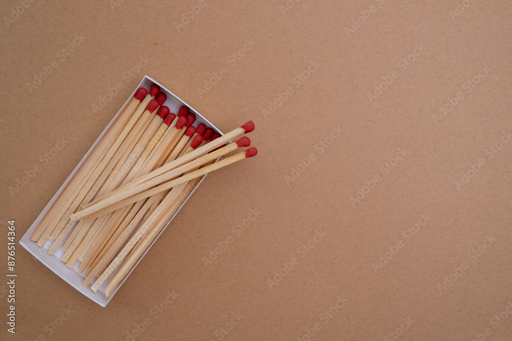 Box with new matchsticks on color background. Scattered wooden matches without a box close-up. Design
