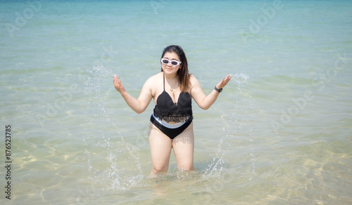 Woman young asian fat chubby cute beautiful smile happy fun enjoy relax fredom bikini swimwear body sexy front view sea beach white sand clean blue sky calm nature ocean wave water travel on holiday photo