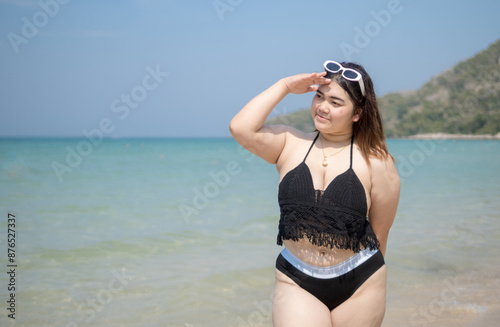 Woman young asian fat chubby cute beautiful smile happy fun enjoy relax fredom bikini swimwear body sexy front view sea beach white sand clean blue sky calm nature ocean wave water travel on holiday photo