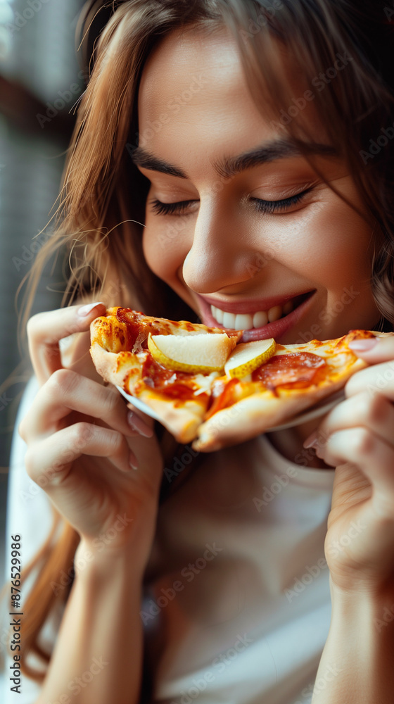 Happy woman eating pizza, smiling, facing camera, pizza in hand, happy woman looking down and eating pizza slice Happy woman eating pizza, smiling, facing camera, pizza in hand, happy woman looking down and eating pizza slice
