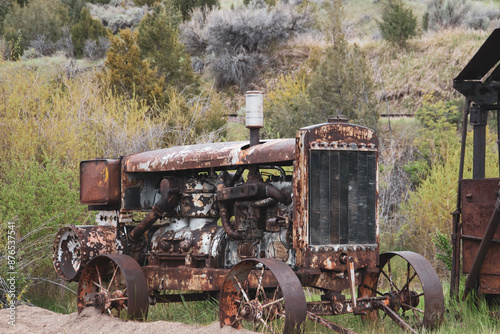 Old rusted tractor left in an abanded mining town.  photo