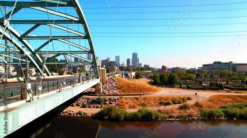 Aerial Shot Of Cars Moving On Bridge Road In Modern City Against Clear Sky, Drone Ascending Forward On Sunny Day - Denver, Colorado