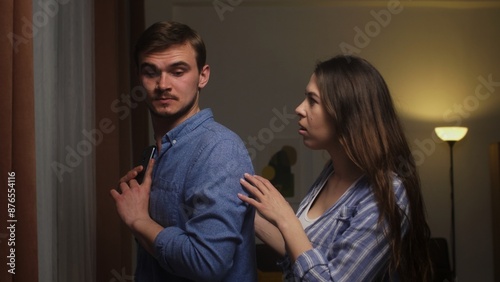 Couple's Tense Moment: Woman Confronting Man Over Secretive Phone Use