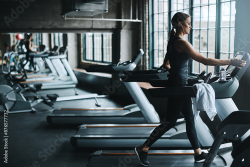 Running, exercise and woman on treadmill in gym listening to music, audio and radio for cardio workout. Sports, wellness and person with earphones for fitness, marathon training and practice for race