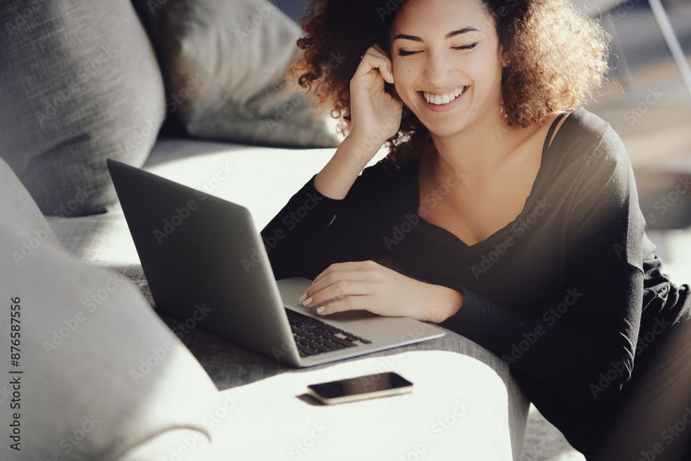 Young woman working from home on laptop and smiling Young woman working from home on laptop and smiling