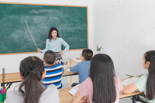 asian female teacher teaching to children group in classroom, she explain and complain because she feeling unhappy, violence and depress in school