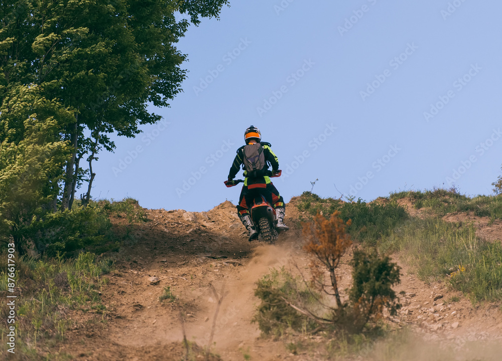 Professional enduro bike rider on action, dirt ride on the muddy road. Motocross sport. Professional enduro bike rider on action, dirt ride on the muddy road. Motocross sport.