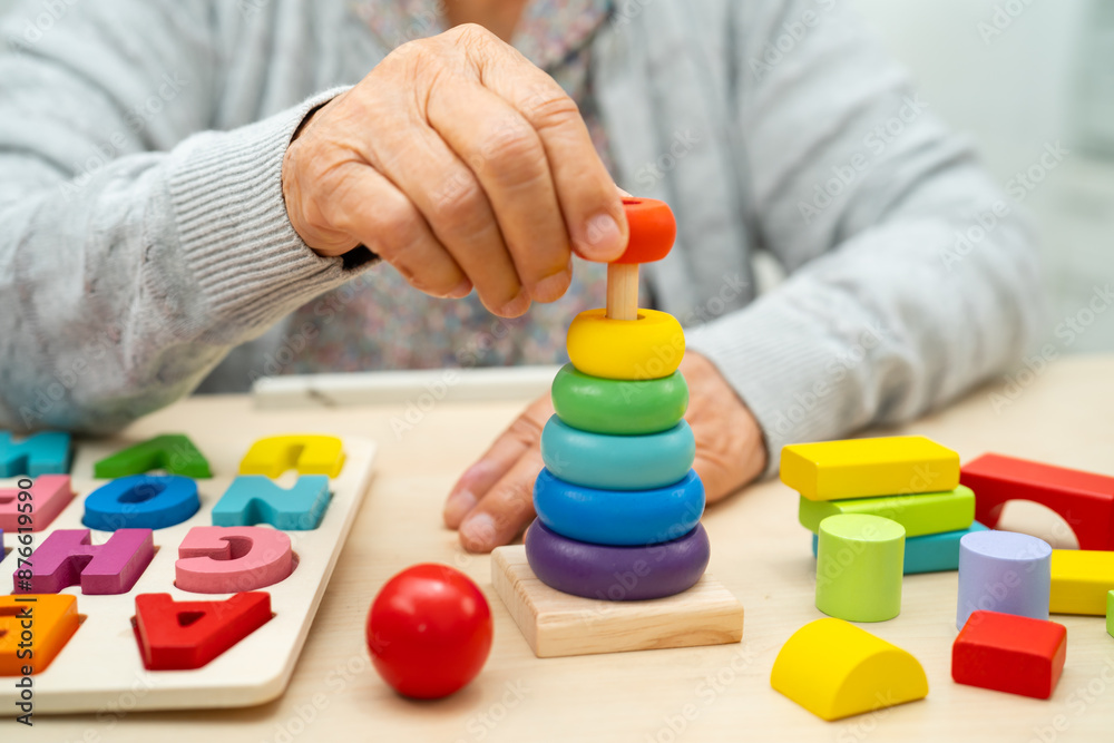 Alzheimer disease AD, Asian senior woman patient suffering from dementia learn practical motor skills rehabilitation. Alzheimer disease AD, Asian senior woman patient suffering from dementia learn practical motor skills rehabilitation.