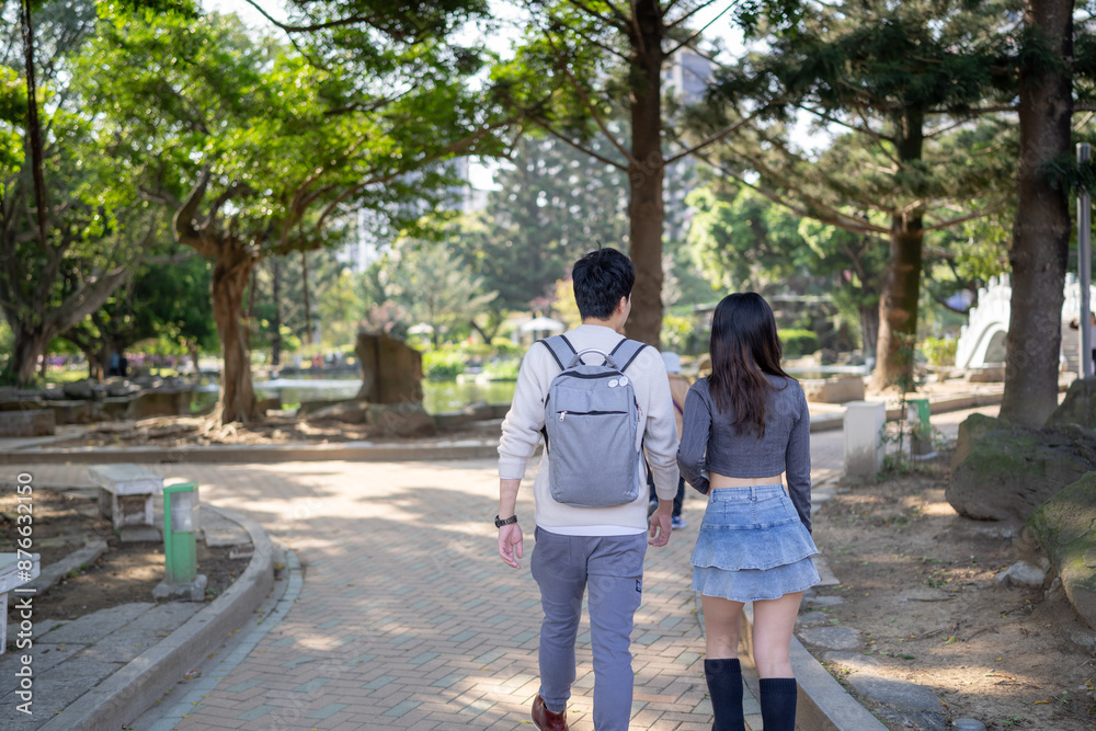 In March, a Taiwanese woman in her twenties and a Hong Kong man are walking in a park near Zhongshan Memorial Hall in Zhongzheng District, Taipei City, Taiwan.