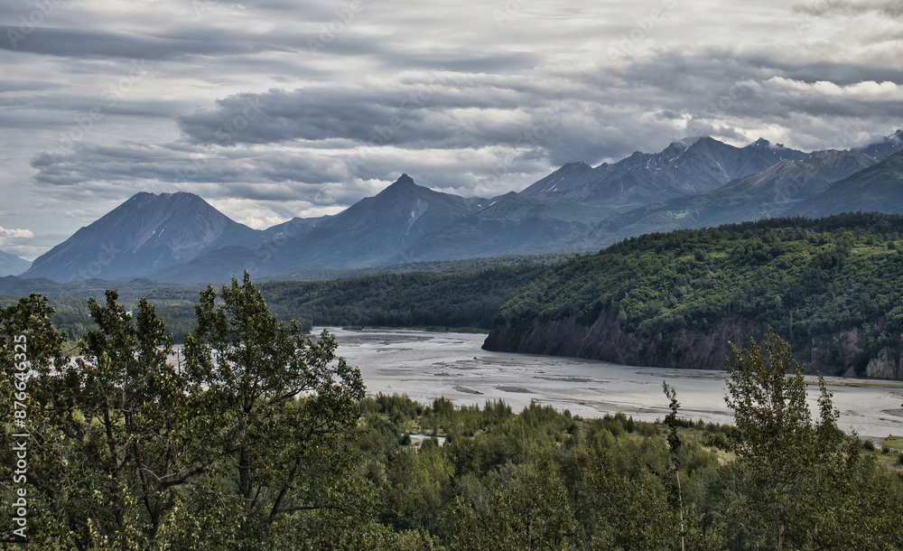 Trees, river and mountains on a cloudy summer day at Matanuska-Susitna Valley in Alaska near Palmer. Trees, river and mountains on a cloudy summer day at Matanuska-Susitna Valley in Alaska near Palmer.