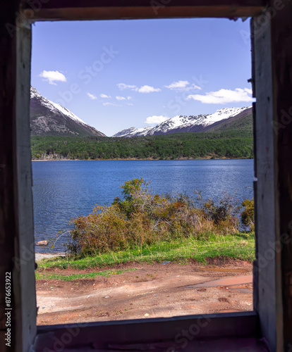 Laguna Bombilla and the snow-capped mountains from the window. Tolhuin, Patagonia Argentina photo