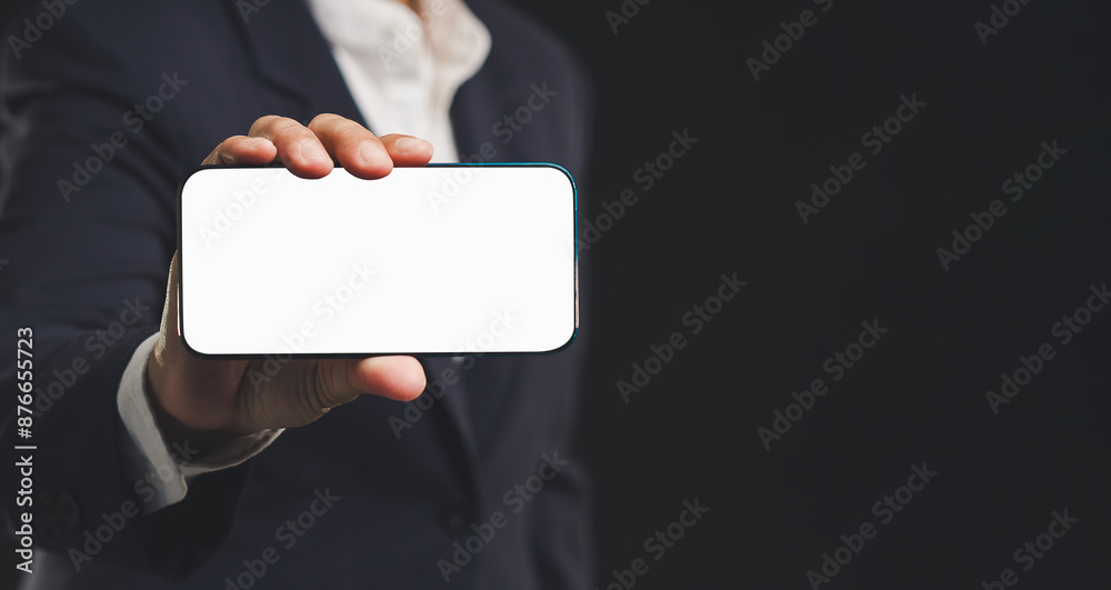Hand holding smartphone with bank screen while standing on a black background. Hand holding smartphone with bank screen while standing on a black background.