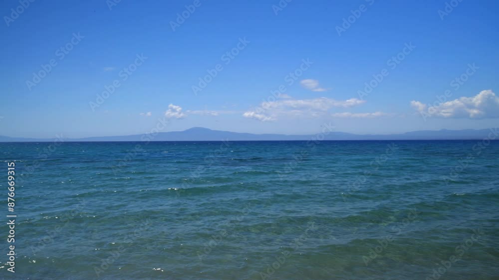Wide panoramic , pan right movement astonishing blue colours at sea of Kalamata, Peloponnese , Greece with beautiful clouds in the blue sky 4k Wide panoramic , pan right movement astonishing blue colours at sea of Kalamata, Peloponnese , Greece with beautiful clouds in the blue sky 4k