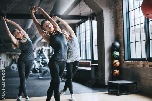 Women, people and stretching with fitness, exercise and balance with workout, active and performance. Healthy group, athlete or friends in wellness center, routine and cardio with warm up or training