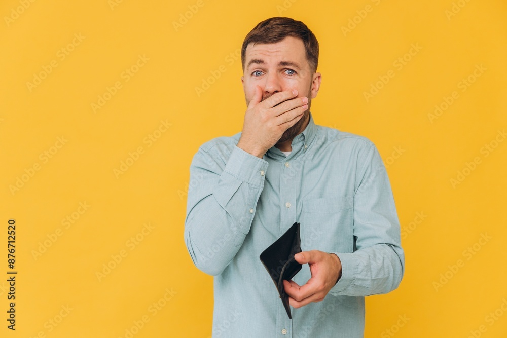 I'm Broke. Portrait of sad unshaven male bankrupt showing his empty wallet looking at camera. Upset man standing isolated over yellow studio background. Poverty Concept. Lack of money I'm Broke. Portrait of sad unshaven male bankrupt showing his empty wallet looking at camera. Upset man standing isolated over yellow studio background. Poverty Concept. Lack of money