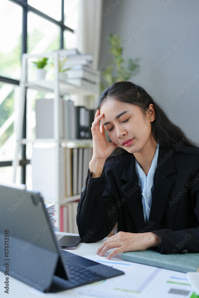 Asian businesswomen, tired, stressed office workers, headaches over delayed work hours. The work was not completed according to the supervisor's goals. Assigned executives Office syndrome concept. Asian businesswomen, tired, stressed office workers, headaches over delayed work hours. The work was not completed according to the supervisor's goals. Assigned executives Office syndrome concept.
