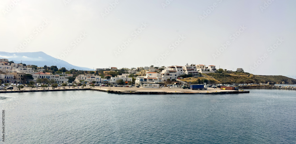 Obraz premium Andros island, Cyclades Greece. Moored speedboat in harbour clear sea water, vehicle, blue sky.
