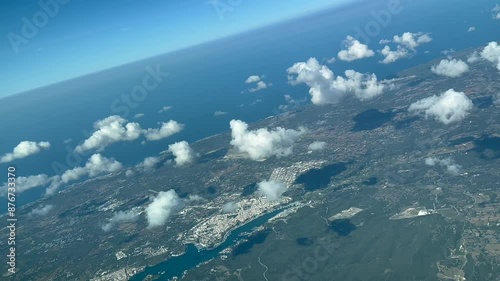 POV of Mahon Bay in Menorca Island, Spain, shot from an airplane cabin at 3000m high. 4K 60FPS photo