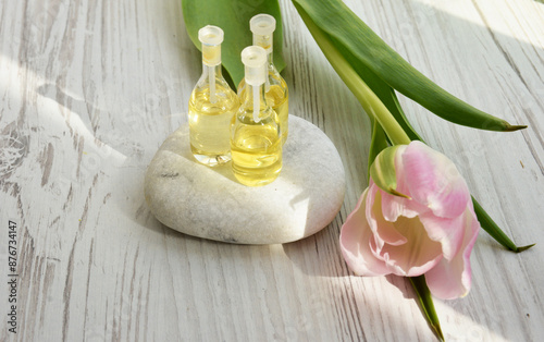 Spa concept. White spa stone and aroma oils with space for text. Meditation and minimalism. copyspase flatlay photo