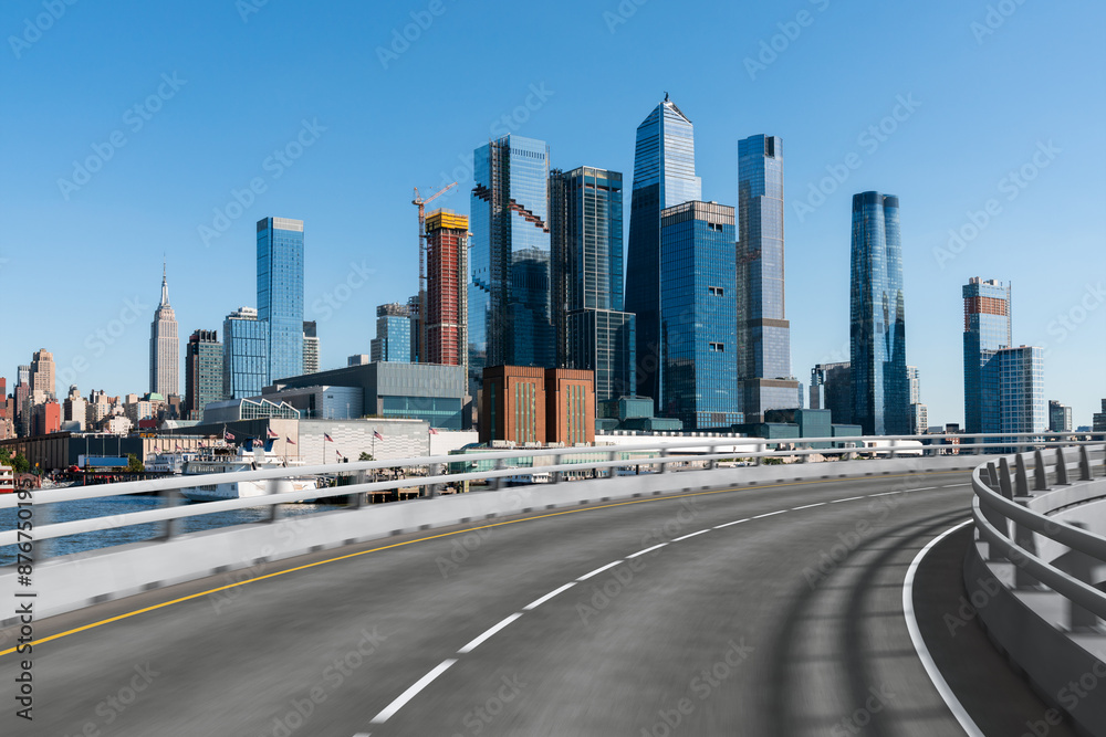 Empty urban asphalt road exterior with city buildings background. New modern highway concrete construction. Concept of way to success. Transportation logistic industry fast delivery. New York. USA. Empty urban asphalt road exterior with city buildings background. New modern highway concrete construction. Concept of way to success. Transportation logistic industry fast delivery. New York. USA.