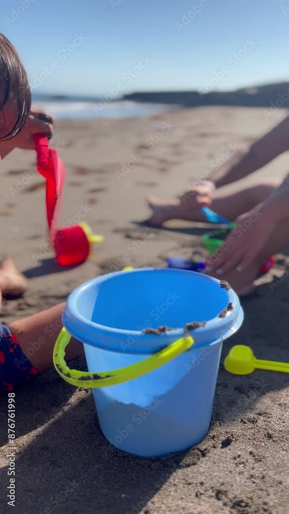 Child playing with sand and sea with the sea in the background on summer vacation Child playing with sand and sea with the sea in the background on summer vacation