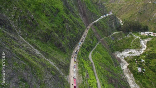 Central highway Lima, Peru. A landslide (huaico) blocks a road through steep hills. The drone footage shifts focus from the road to the horizon, showing halted traffic due to the road closure. photo