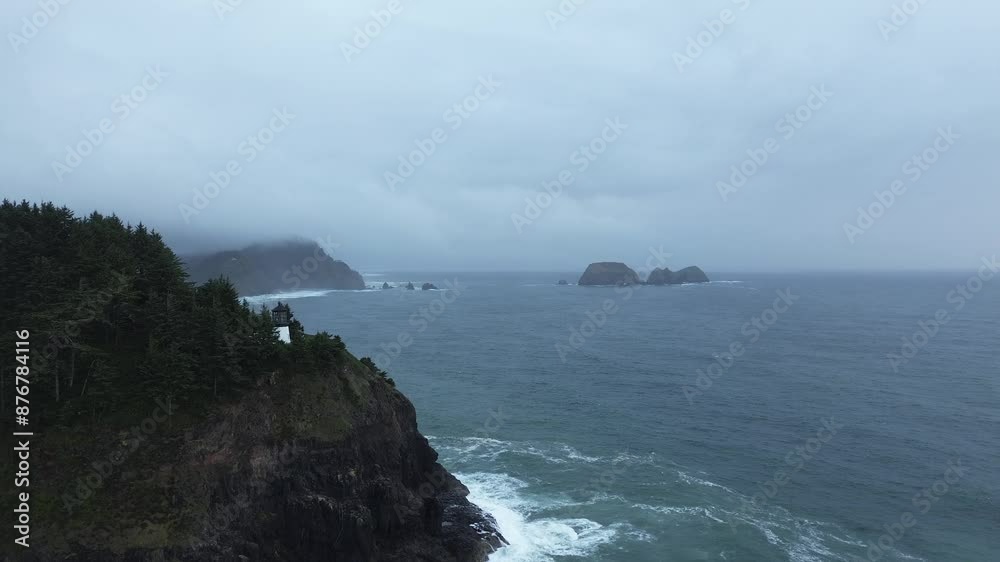 Flying over Foggy Coastal Cliff with Waves Crashing Below and Dense Forest Above Flying over Foggy Coastal Cliff with Waves Crashing Below and Dense Forest Above