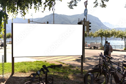White billboard in Lugano next to the lake.