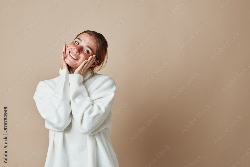 Portrait of smiling young woman in white sweater and glasses isolated on beige background, beauty and fashion concept Portrait of smiling young woman in white sweater and glasses isolated on beige background, beauty and fashion concept