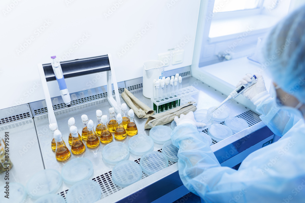 female laboratory assistant conducts research, chemical analysis, analysis of bacteria female laboratory assistant conducts research, chemical analysis, analysis of bacteria