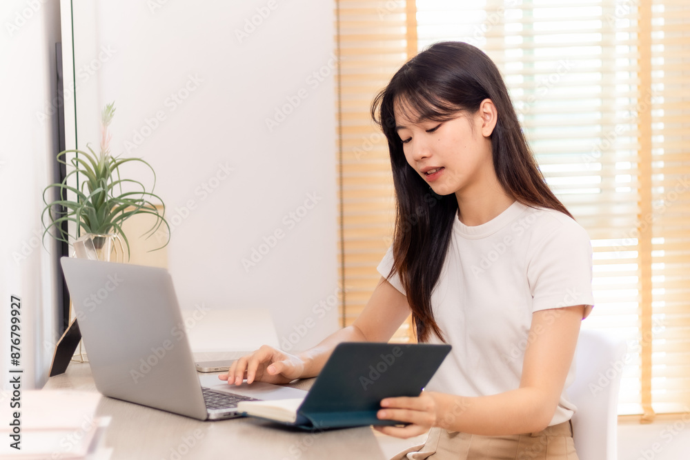 Woman meeting online on her laptop and smartphone at home Woman meeting online on her laptop and smartphone at home