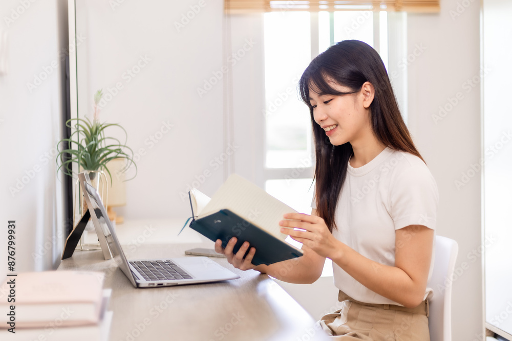 Woman meeting online on her laptop and smartphone at home Woman meeting online on her laptop and smartphone at home