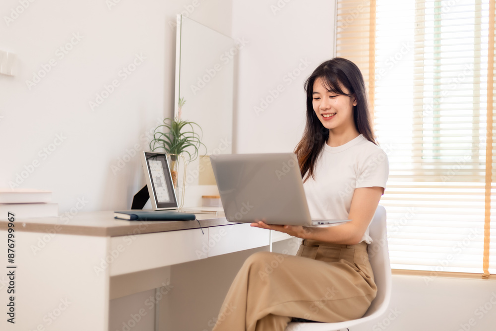 Woman meeting online on her laptop and smartphone at home Woman meeting online on her laptop and smartphone at home