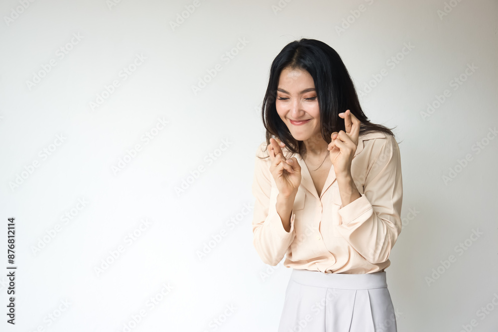Excited adult Asian woman with black long hair showing wishing with finger crossed gesture, isolated backgorund Excited adult Asian woman with black long hair showing wishing with finger crossed gesture, isolated backgorund