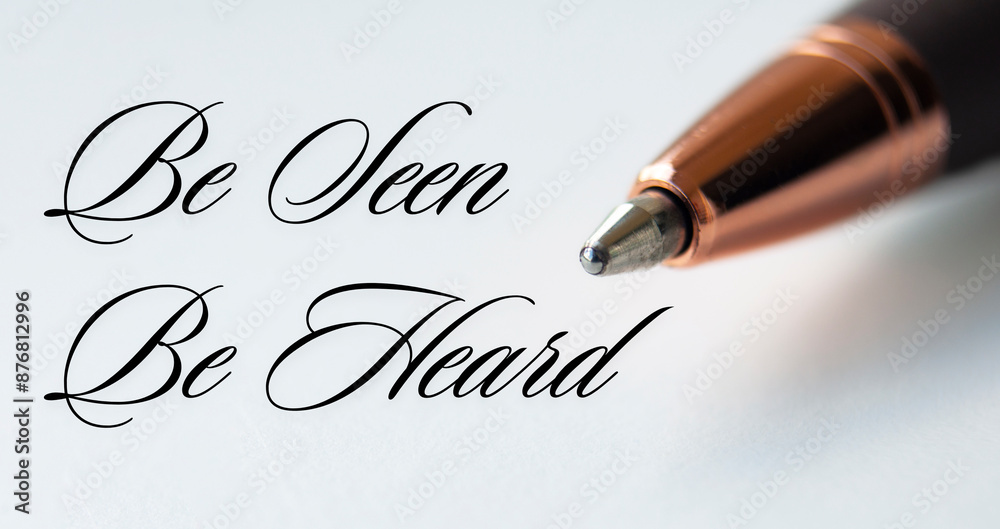 Fototapeta premium Be seen be heard text with closeup pen on white cover background