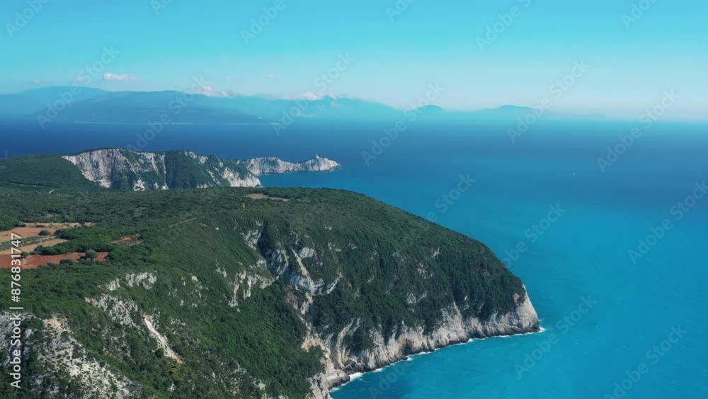 High angle view capturing the serene beauty of a coastal cliffside against a vivid blue ocean, showcasing nature's grandeur. High angle view capturing the serene beauty of a coastal cliffside against a vivid blue ocean, showcasing nature's grandeur.