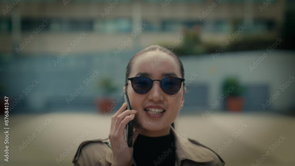 Young asian businesswoman communting to work outside modern office building. Young asian businesswoman communting to work outside modern office building.