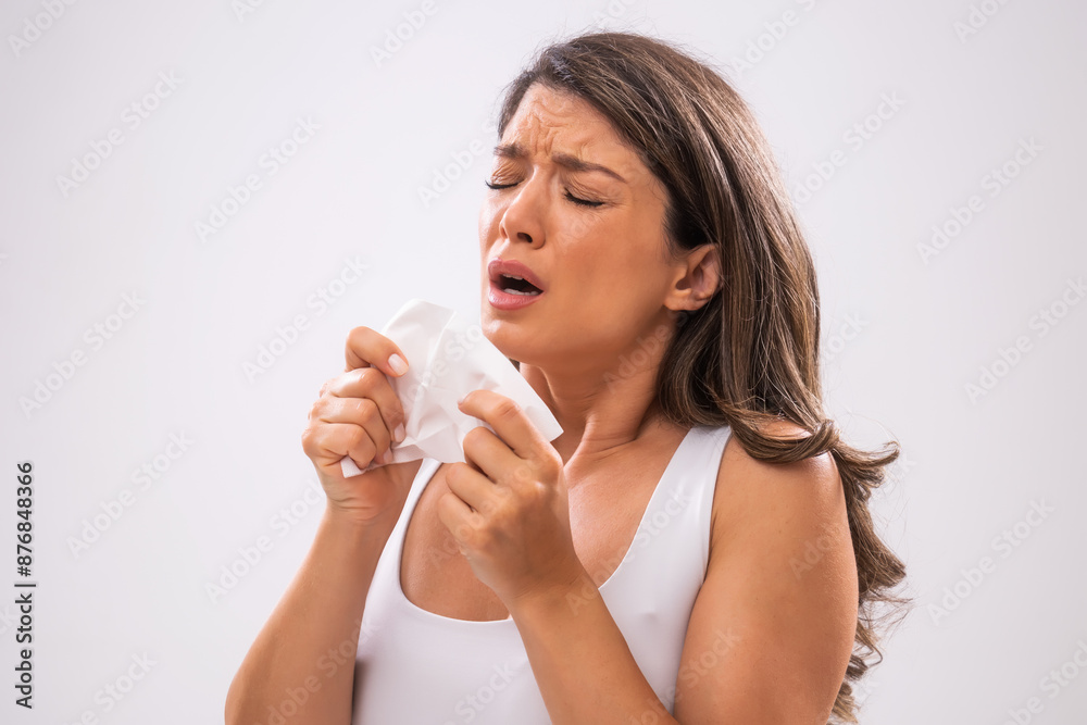Portrait of adult woman who is sneezing. Portrait of adult woman who is sneezing.