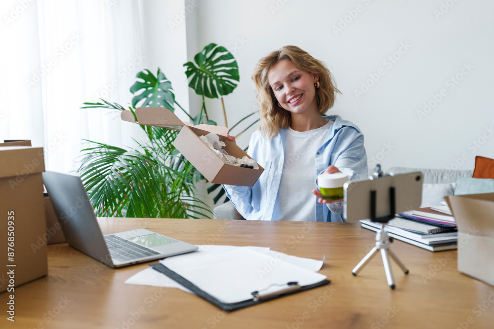 Businesswoman making social media content through smart phone at home office Businesswoman making social media content through smart phone at home office