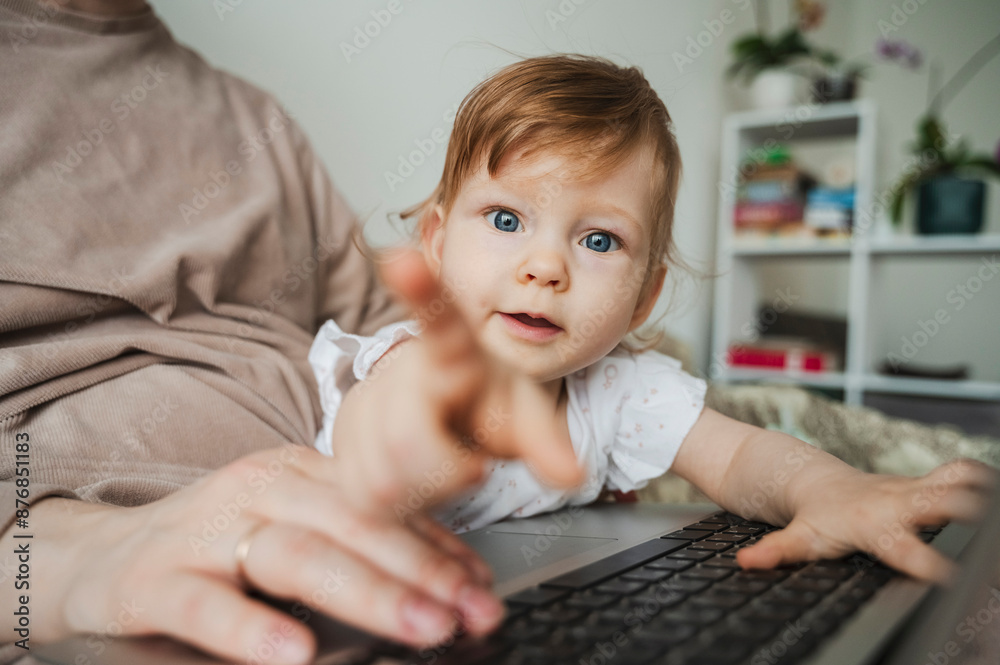 Cute toddler with working mother in bedroom at home Cute toddler with working mother in bedroom at home