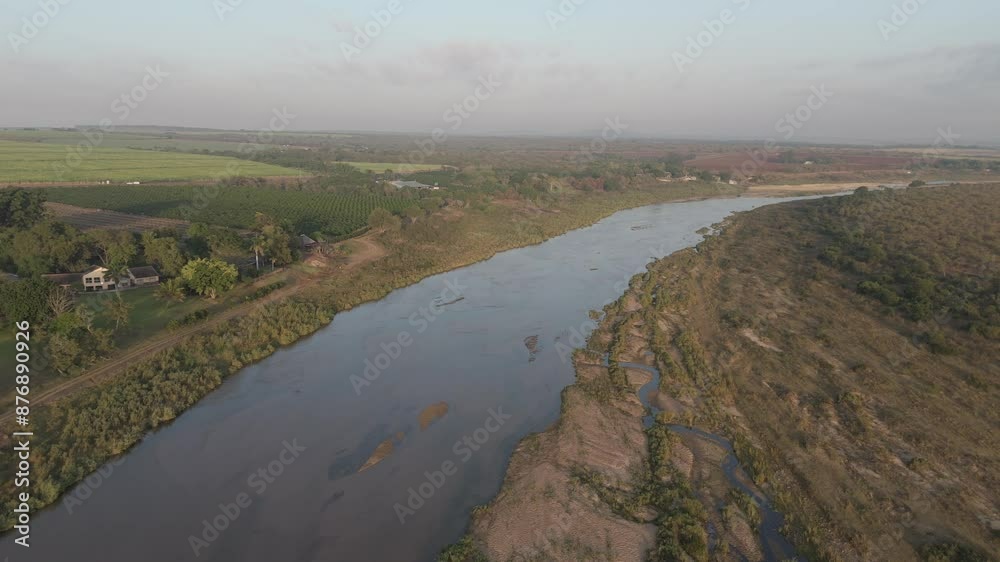 High aerial view of seasonal or ephemeral crocodile river by farmlands bordering the Kruger National Park. South Africa. High aerial view of seasonal or ephemeral crocodile river by farmlands bordering the Kruger National Park. South Africa.