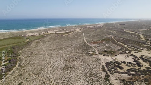 Culatra island in portugal showcasing sandy dunes, green patches, and the atlantic ocean, aerial view photo