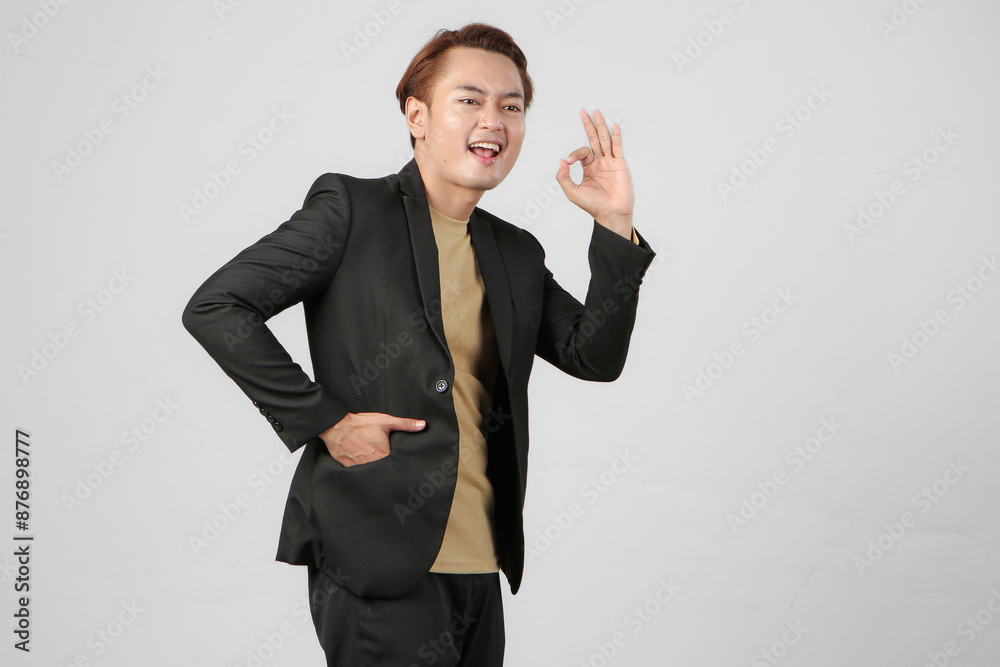 portrait of happy asian businessman wearing suit giving approval ok sign finger on isolated background portrait of happy asian businessman wearing suit giving approval ok sign finger on isolated background