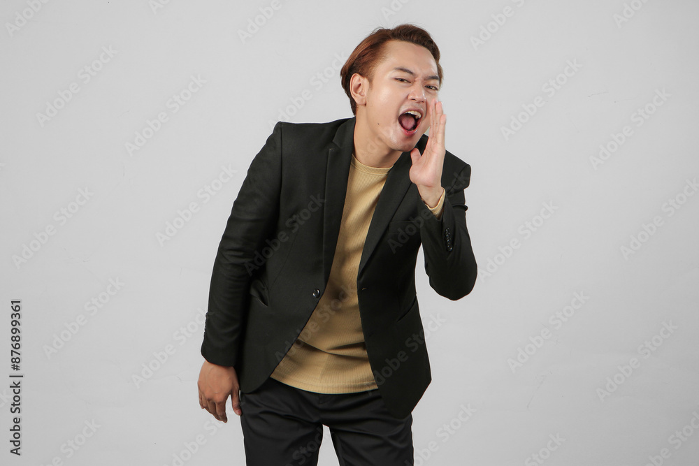 portrait of happy asian businessman wearing suit shouting with cupping hand on isolated background portrait of happy asian businessman wearing suit shouting with cupping hand on isolated background