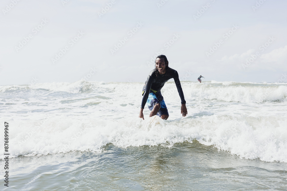 portrait of latin surfer man rides the tropical waves in Mexico Latin America, hispanic people surfing in summer sport activity portrait of latin surfer man rides the tropical waves in Mexico Latin America, hispanic people surfing in summer sport activity